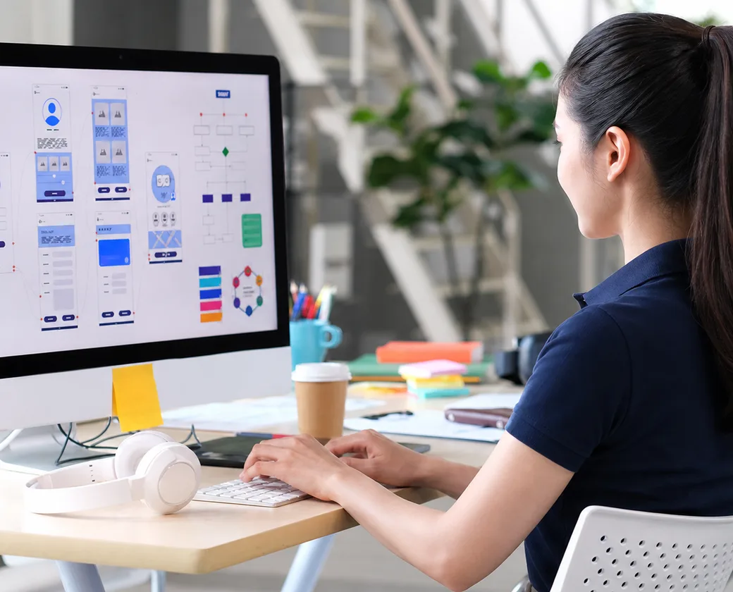 Nhân viên BizMaC rà bản phác thảo giao diện và luồng trang trên màn hình khi nhận web